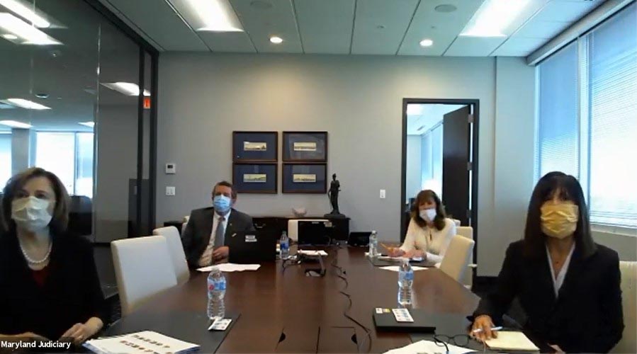Photo of Maryland Judiciary leadership in conference room discussing COVID-19 via videoconferencing