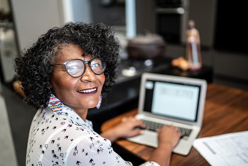 woman at computer looking at camera