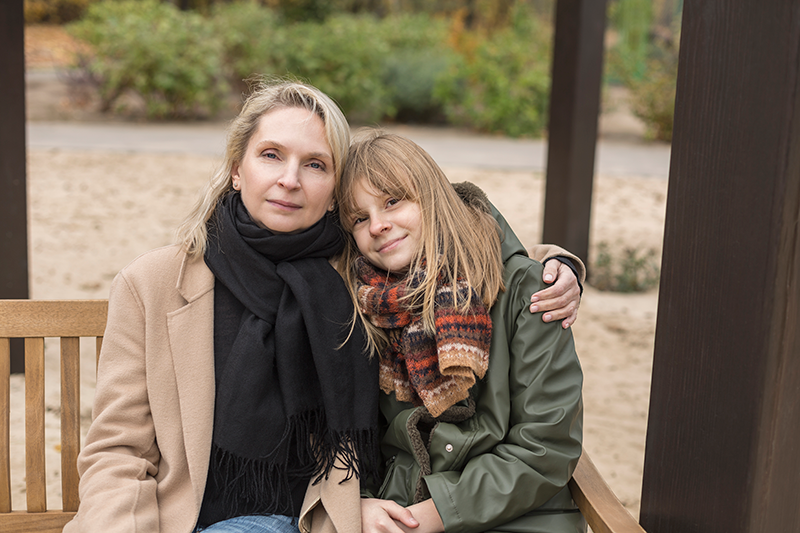 woman and daughter sitting down on bench