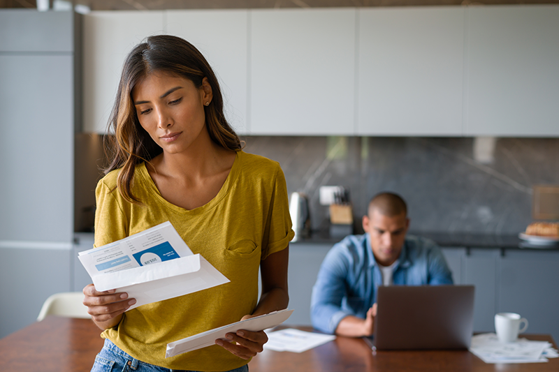 woman standing looking at paperwork